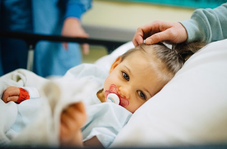 girl in hospital bed preparing for pediatric surgery